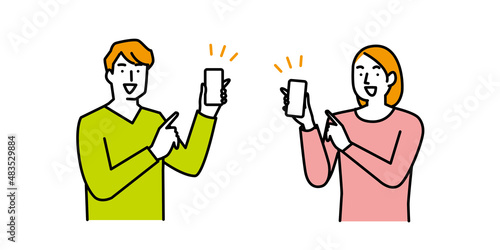 スマートフォンを指差す笑顔の男性と女性