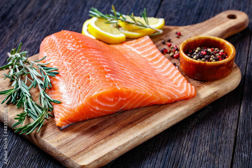 Fresh salmon fish fillet on wooden board Fresh salmon fish fillet on wooden board