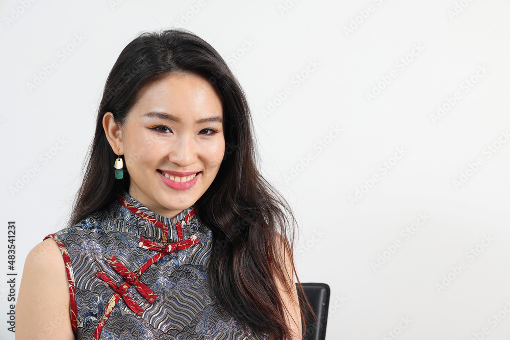 Beautiful young elegant southeast Asian woman wearing modern Chinese cheongsam dress pose smile look Beautiful young elegant southeast Asian woman wearing modern Chinese cheongsam dress pose smile look