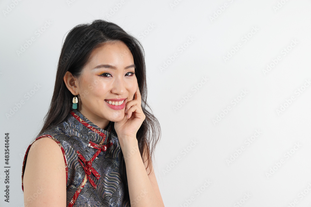 Beautiful young elegant southeast Asian woman wearing modern Chinese cheongsam dress pose smile look Beautiful young elegant southeast Asian woman wearing modern Chinese cheongsam dress pose smile look
