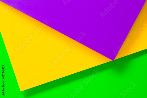 Three colors of paper with its texture as a copy space background for the Mardi Gras carnival
