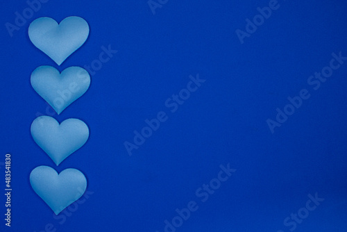 four blue hearts on a blue background