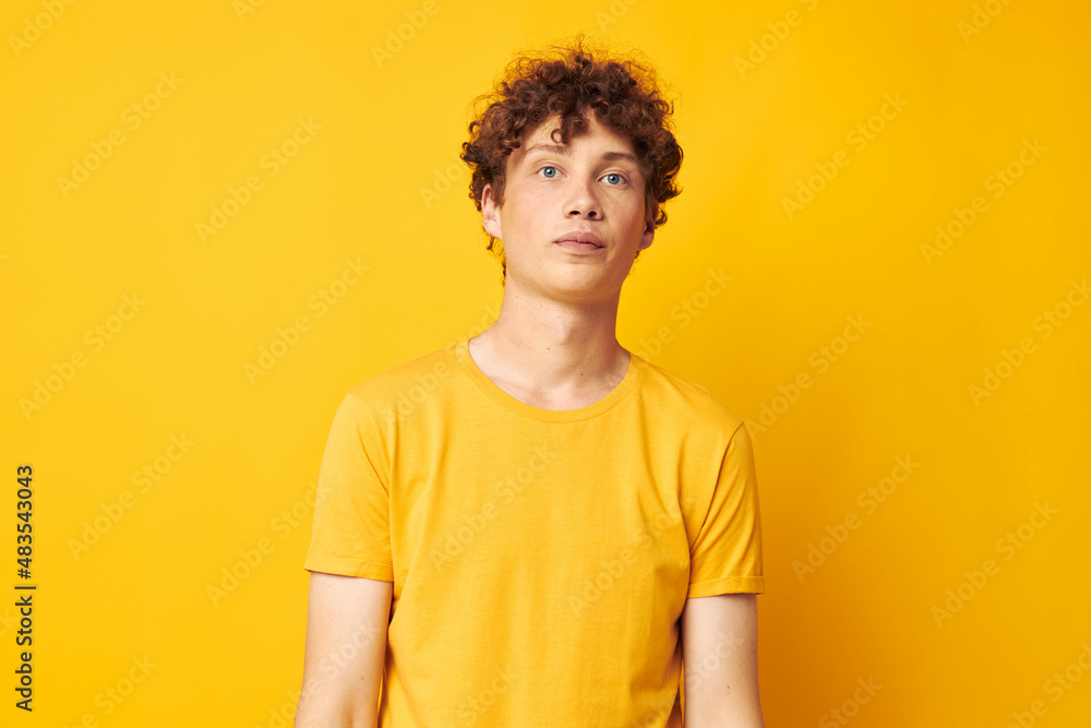 Young curly-haired man Youth style studio casual wear isolated background unaltered Young curly-haired man Youth style studio casual wear isolated background unaltered