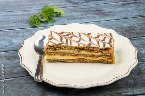 millefeuille in a white plate on a gray background photo