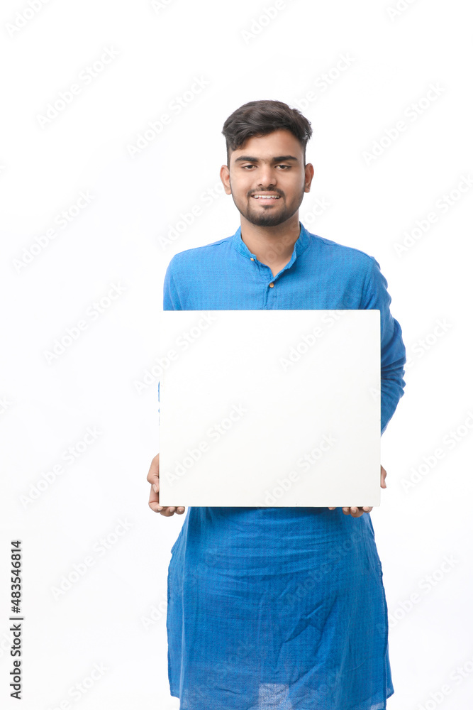 Indian man wearing traditional cloths and showing board on white background. Indian man wearing traditional cloths and showing board on white background.