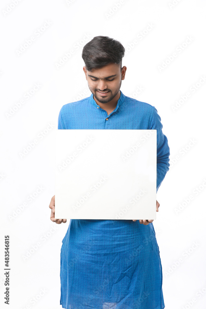 Indian man wearing traditional cloths and showing board on white background. Indian man wearing traditional cloths and showing board on white background.