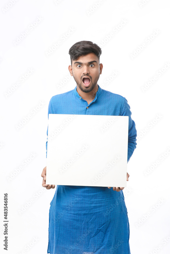 Indian man wearing traditional cloths and showing board on white background. Indian man wearing traditional cloths and showing board on white background.