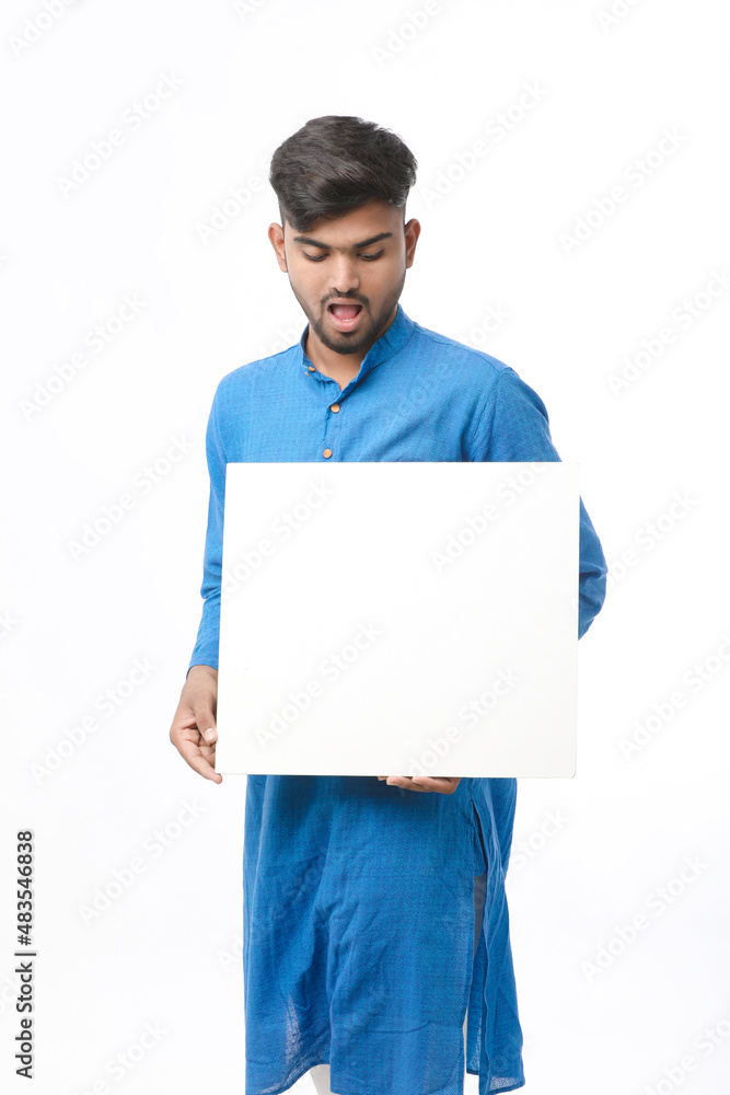 Indian man wearing traditional cloths and showing board on white background. Indian man wearing traditional cloths and showing board on white background.