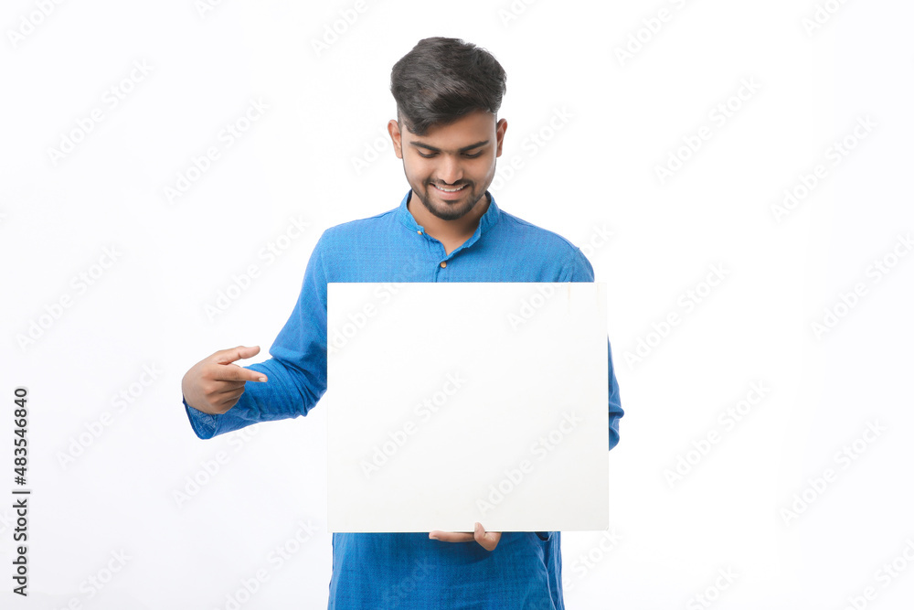 Indian man wearing traditional cloths and showing board on white background. Indian man wearing traditional cloths and showing board on white background.