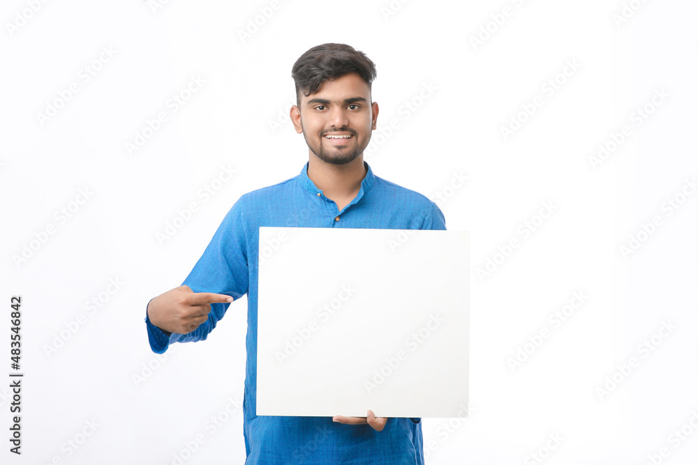 Indian man wearing traditional cloths and showing board on white background. Indian man wearing traditional cloths and showing board on white background.