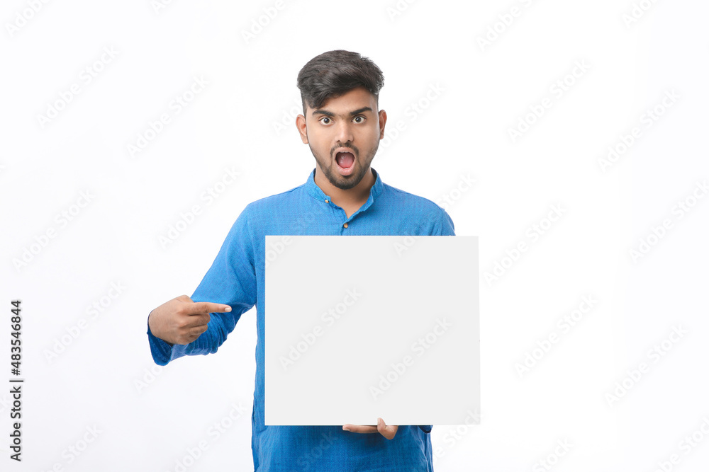 Indian man wearing traditional cloths and showing board on white background. Indian man wearing traditional cloths and showing board on white background.