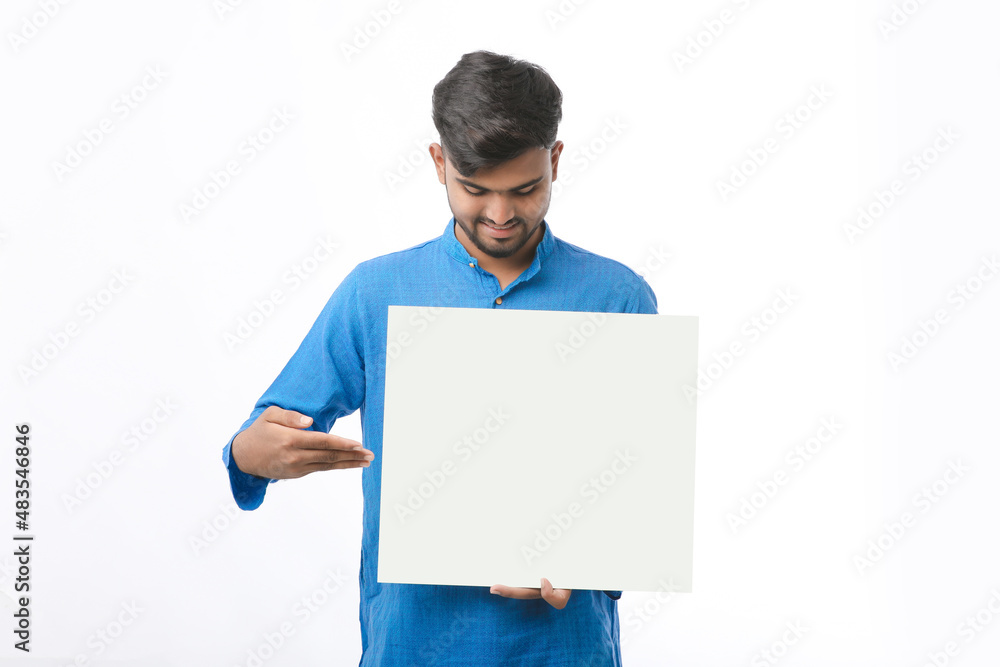 Indian man wearing traditional cloths and showing board on white background. Indian man wearing traditional cloths and showing board on white background.