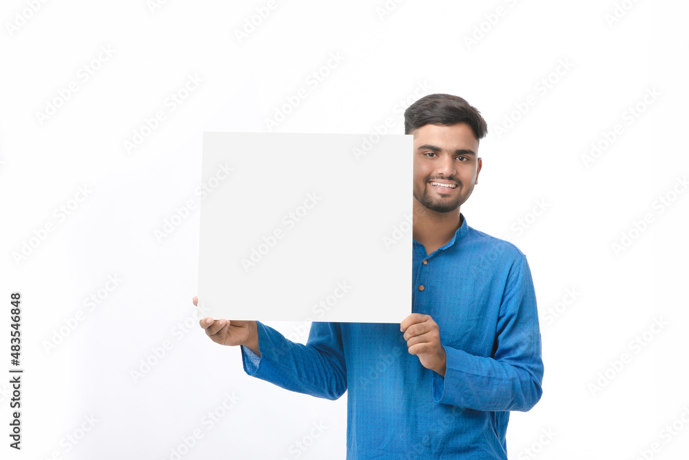 Indian man wearing traditional cloths and showing board on white background. Indian man wearing traditional cloths and showing board on white background.