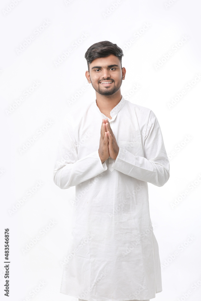 Young indian man in traditional wear and giving namaste or welcome gesture. Young indian man in traditional wear and giving namaste or welcome gesture.
