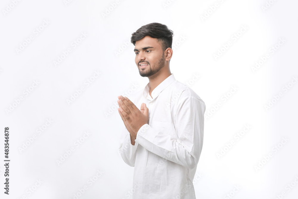 Young indian man in traditional wear and giving namaste or welcome gesture. Young indian man in traditional wear and giving namaste or welcome gesture.