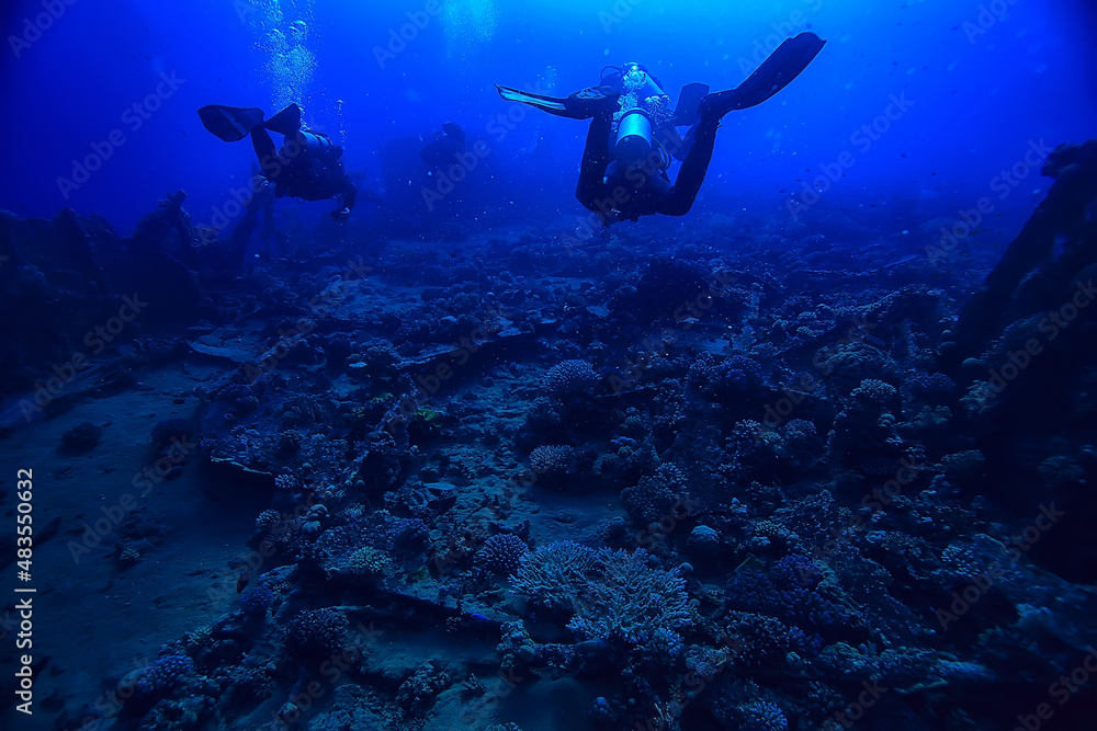 Fototapeta premium divers underwater at depth in the blue sea background