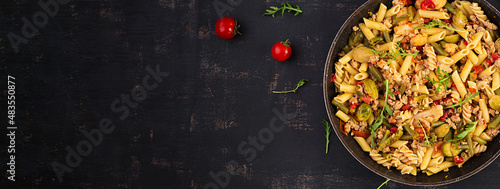 Italian pasta penne and fusilli with minced meat and vegetables. Lunch. Top view, banner