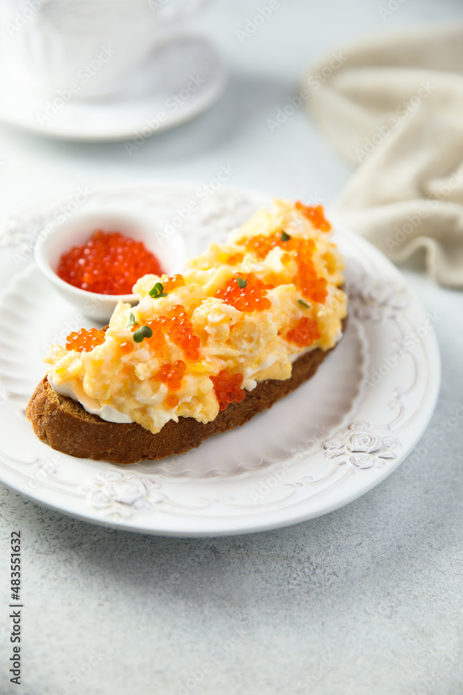 Scrambled eggs toast with cream cheese and caviar