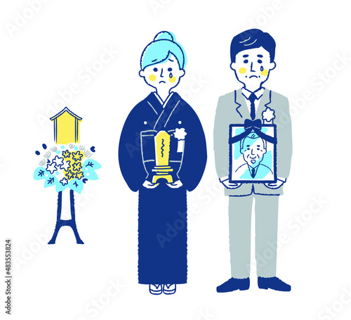 遺影と位牌を持っている遺族と献花
