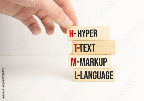 Closeup man add more some alphabets wood cubes into the row to complete the word html, converge benefits, mutal benefits concept photo