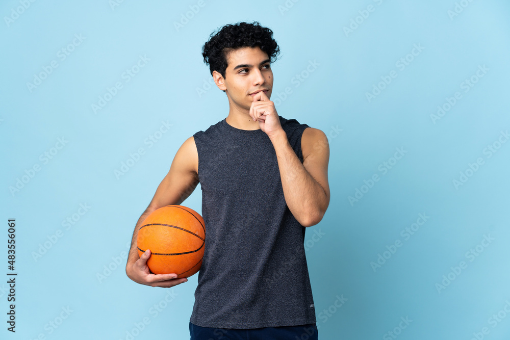 Venezuelan basketball player man over isolated background and looking up