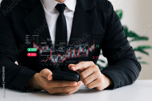 Businessmen work with stock market investments using tablets to analyze trading data. smartphone with stock exchange graph on screen. Financial stock market.