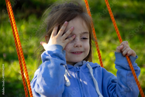Little girl swinging on a swing