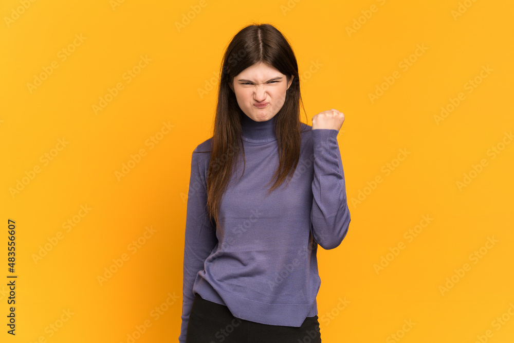 Young Ukrainian girl isolated on yellow background with unhappy expression Young Ukrainian girl isolated on yellow background with unhappy expression