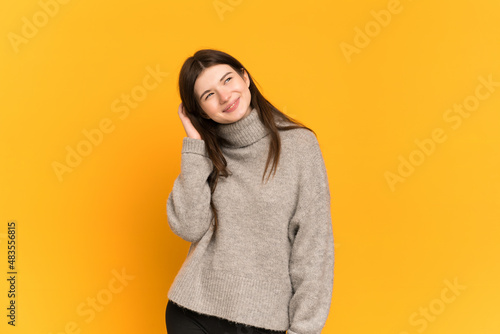 Young Ukrainian girl isolated on yellow background thinking an idea © luismolinero