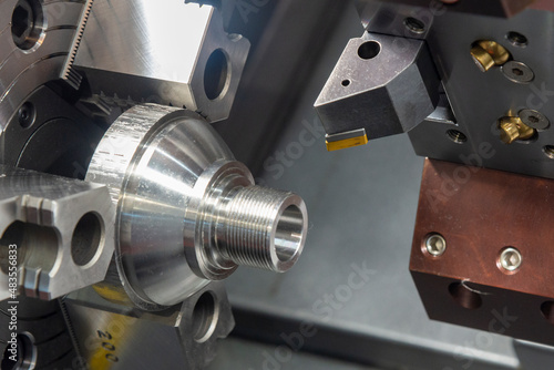 The CNC lathe machine thread cutting the metal cone shape parts.