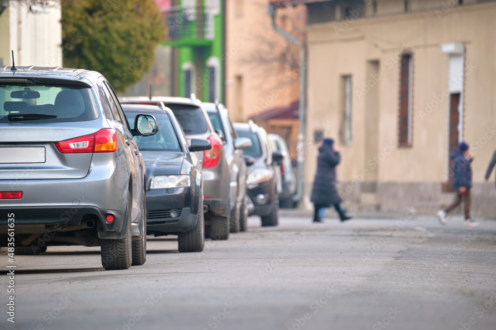 City traffic with cars parked in line on street side City traffic with cars parked in line on street side