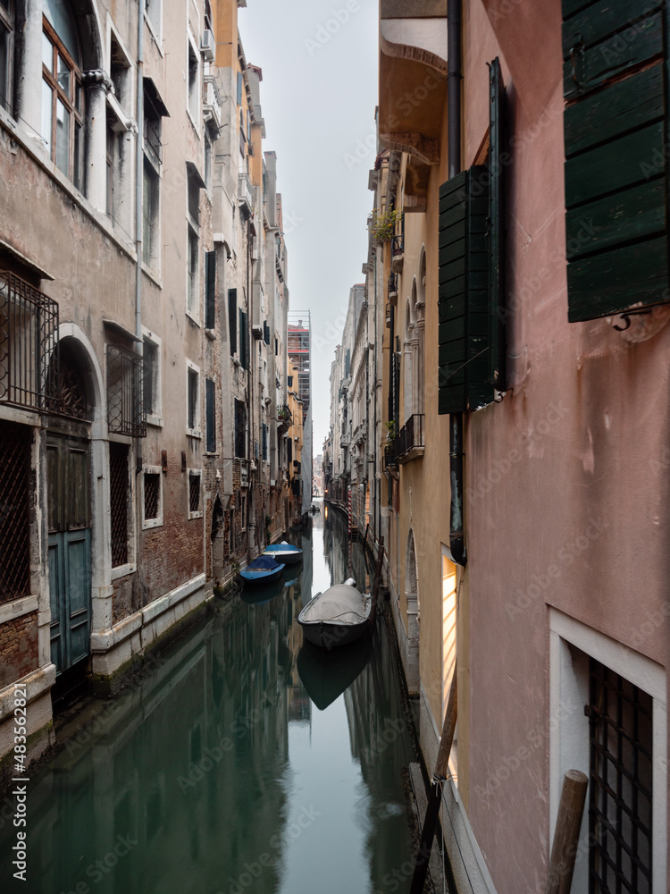 Small Canal with Boats in Venice, Italy on a Cold Winter Day