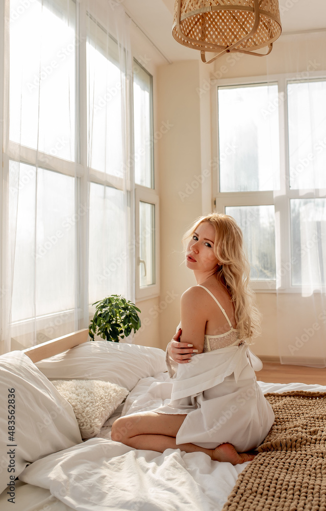 Girl in underwear sits on the bed and poses Girl in underwear sits on the bed and poses