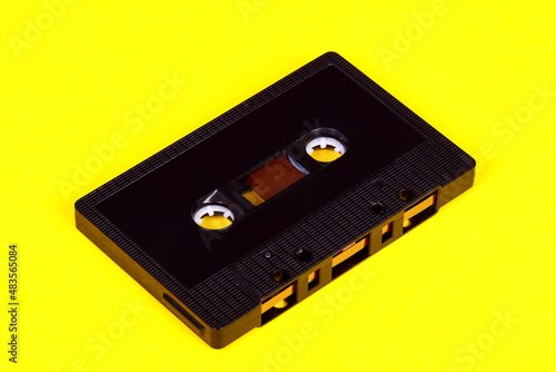 Vintage retro audio cassette tape isolated on a yellow background