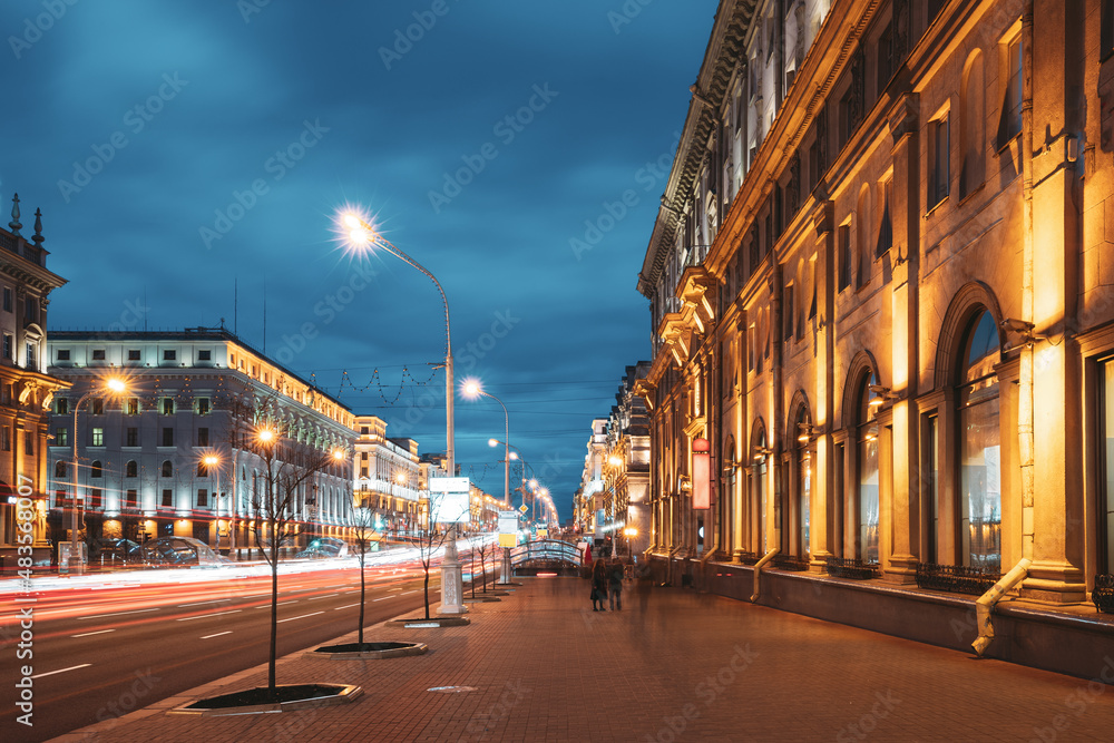 Minsk, Belarus. Traffic On Independence Avenue In Evening Night Illuminations.