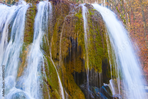 closeup small waterfall on mountain river rushing through the mountain canyon
