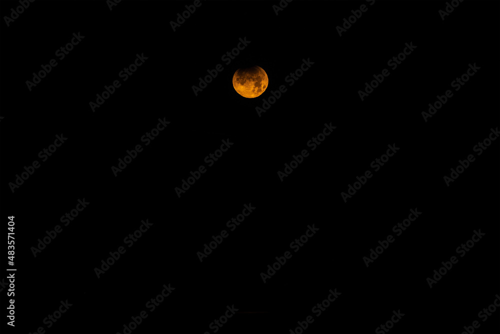 Landscape image of part lunar eclipse during November 2021 which conincided with blood red moon phoase Landscape image of part lunar eclipse during November 2021 which conincided with blood red moon phoase