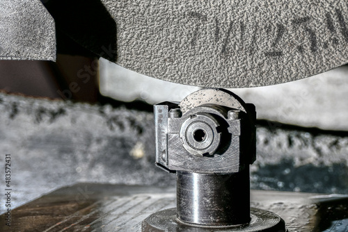 Abrasive grinding stone on a surface grinder with the correct cone installed before cleaning the wheel from sticking and leveling the roughing plane.