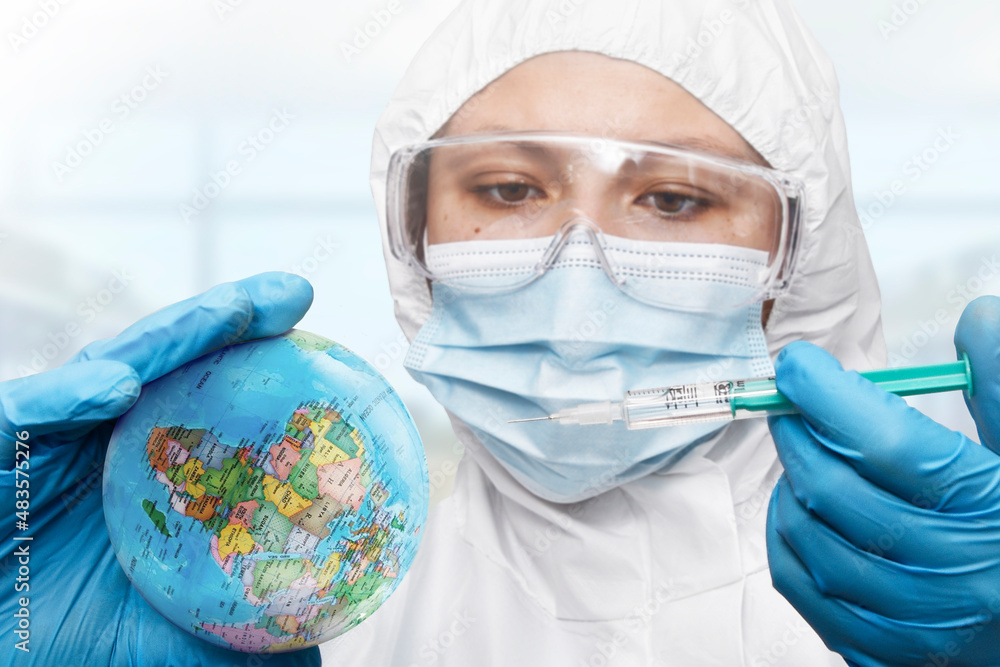 Doctor hand wearing glove injecting syringe of Coronavirus vaccine concept, syringe of vaccine and needle planting on the planet earth , Coronavirus COVID-19 Doctor hand wearing glove injecting syringe of Coronavirus vaccine concept, syringe of vaccine and needle planting on the planet earth , Coronavirus COVID-19