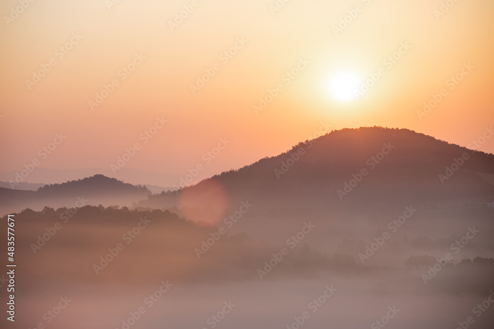 Beautiful sunrise landscape of  amazing mountain in fog.