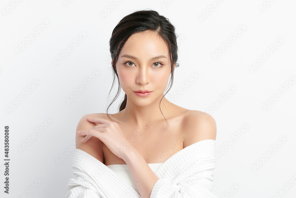 Beautiful young Asian woman wearing bathrobe on white background, Face care, Facial treatment, Cosmetology, beauty and spa Concept. Beautiful young Asian woman wearing bathrobe on white background, Face care, Facial treatment, Cosmetology, beauty and spa Concept.