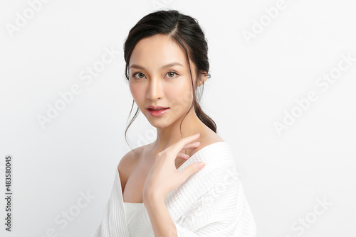 Beautiful young Asian woman wearing bathrobe on white background, Face care, Facial treatment, Cosmetology, beauty and spa Concept.