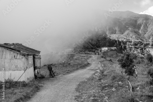 Dramatic black and white image of a small village 8000 feet high in the Caribbean mountains of the Dominican Republic, with misty fog.