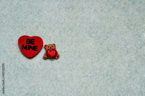 Be mine on a red heart with a little bear isolated on white background