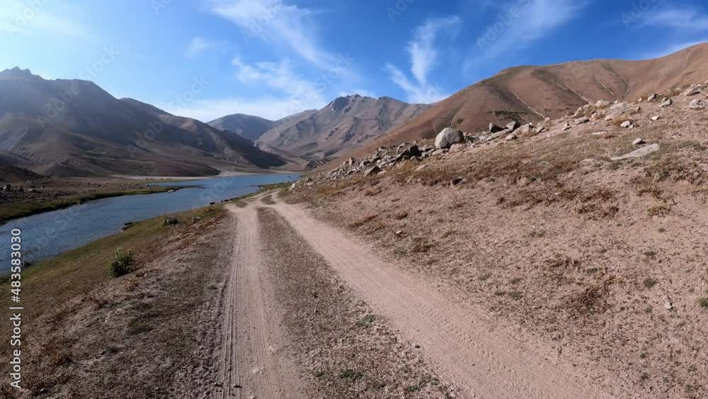Road for a walk near the small lake Arashan at an altitude of 2774 m above sea level and the surrounding mountain landscape Road for a walk near the small lake Arashan at an altitude of 2774 m above sea level and the surrounding mountain landscape