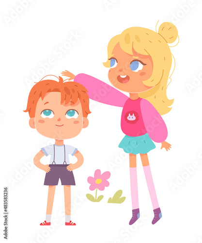 Tall girl measuring progress of height of small preschool boy, children standing together