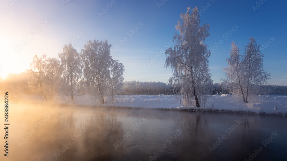 Snow-covered forest on the banks of the winter river, Russia, Ural January Snow-covered forest on the banks of the winter river, Russia, Ural January