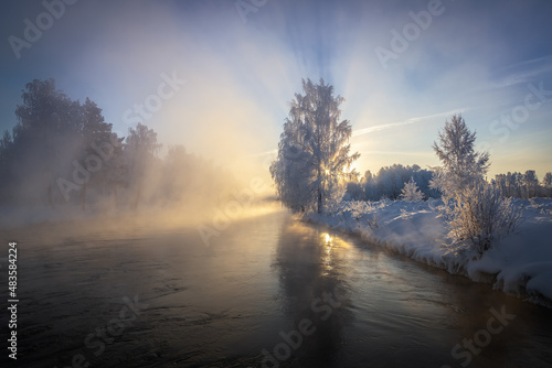 Snow-covered forest on the banks of the winter river, Russia, Ural January