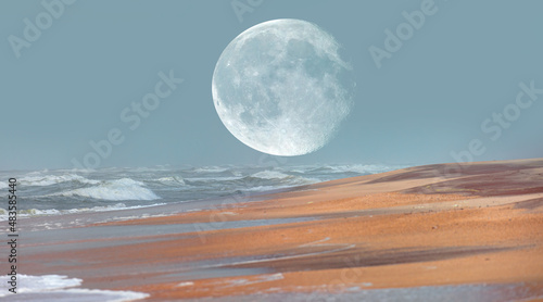 Full moon rising above sea in sunset sky - Namibia  Africa  Elements of this image furnished by NASA 