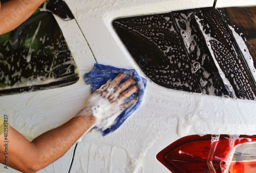 Hand foam washing a white car stock photo
